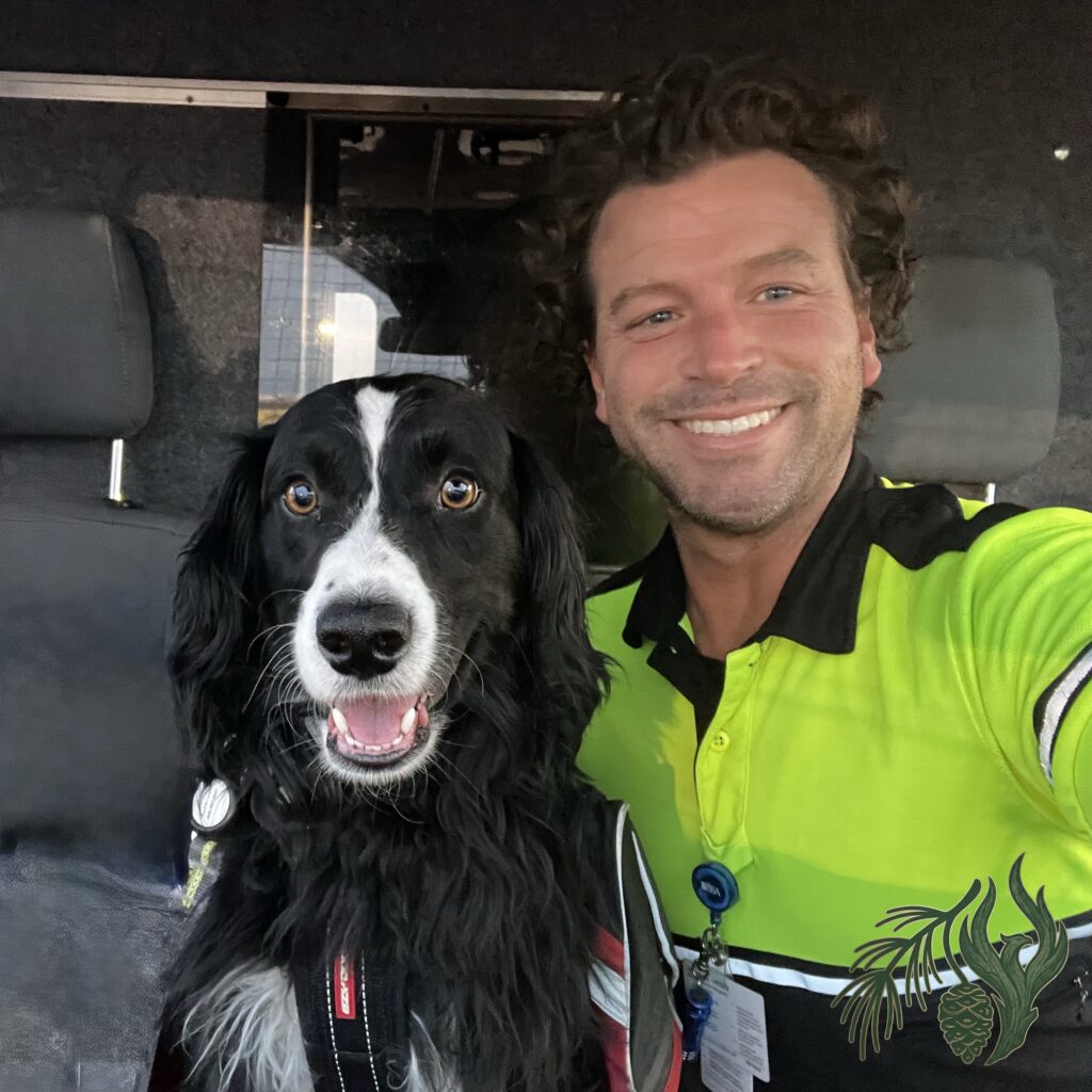 Operational photo of EMS veteran, Kauhlin Lewis (service dog), sitting in an ambulance cab next to his handler (founder), wearing high-visibility gear. This image validates their firsthand experience and drive to offer online therapy throughout Texas to all fellow first responders in the state.